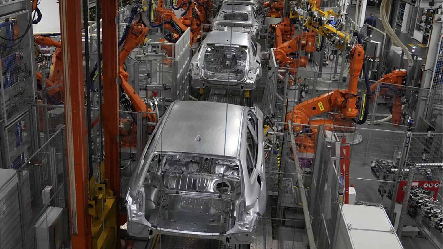 Robots work on cars of German car manufacturer BMW at an assembly line in Munich, Germany, Friday, Oct. 22, 2021. 