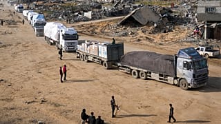 Trucks carrying humanitarian aid enter the Gaza Strip from Egypt in the southern town of Rafah, 12 February, 2025