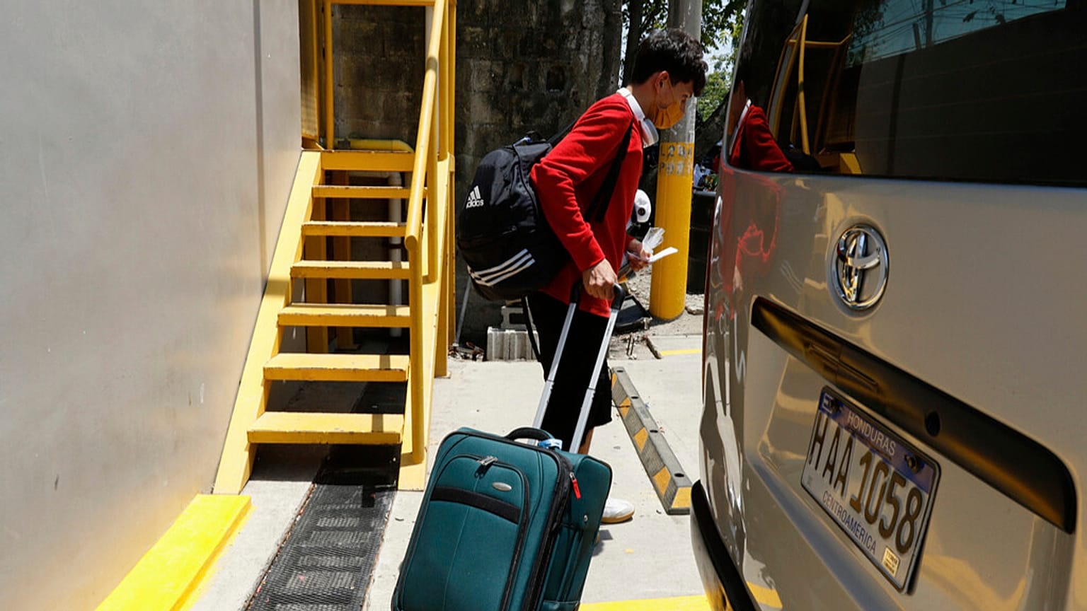A Honduran migrant who returned voluntarily from the United States walks after arriving at Ramon Villeda Morales Airport in San Pedro Sula, Honduras, Monday, May 19, 2025.