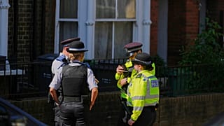 Police community support officers and police officers stand on the street near a house belonging to British Prime Minister Keir Starmer in London, 13 May 2025