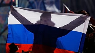 Ein Fan hält während der Medaillenzeremonie bei den Olympischen Winterspielen im Februar 2014 in Sotschi eine russische Flagge.