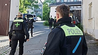 FILE: Police officers search buildings following the ban of the Reichsbürger group "Kingdom of Germany" in Gera, Germany, Tuesday, May 13, 2025