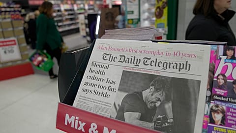The Daily Telegraph newspaper with the front page of French President Emanuel Macron is seen at a supermarket in London, March 21, 2024. 