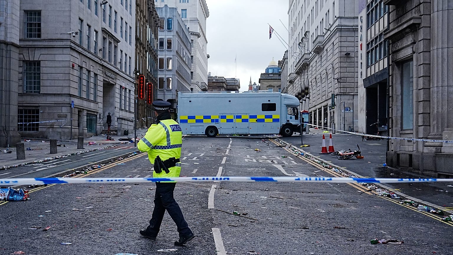 Police work at the scene where a car collided with pedestrians during Monday's Premier League winners parade near the Liver Building in Liverpool, 26 May 2025
