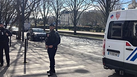 Police officers secure the area near an unexploded World War II-era bomb that caused transportation chaos in Paris, 7 March 2025.