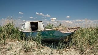 A worn-out boat sits near the dried-up Aral Sea, near Aralsk, 1 July 2023
