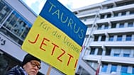 A protester demands the delivery of Taurus cruise missiles to Ukraine on a poster at a solidarity rally for Ukraine in Nuremberg, 24 February, 2024