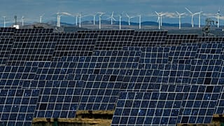 Solar panels work near the small town of Milagro, Navarra Province, northern Spain, Friday, Feb. 24, 2023.