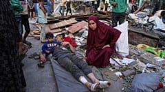 فلسطينيون يتفقدون الأضرار التي لحقت بالمدرسة التي استخدمها السكان النازحون كمأوى والتي تعرضت لغارة إسرائيلية وقتلت 36شخصًا على الأقل، في مدينة غزة 25.05.25