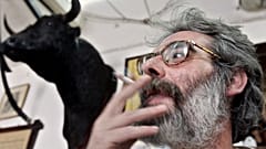 FILE: A man smokes a cigarette in a bar on World No Tobacco Day in Cordoba, 31 May 2005