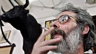 FILE: A man smokes a cigarette in a bar on World No Tobacco Day in Cordoba, 31 May 2005