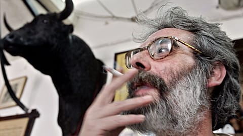 FILE: A man smokes a cigarette in a bar on World No Tobacco Day in Cordoba, 31 May 2005