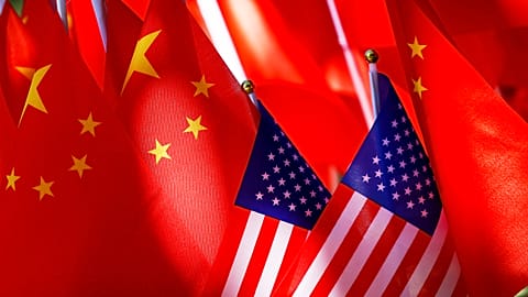 American flags are displayed together with Chinese flags on top of a trishaw. 16 Sept. 2018.