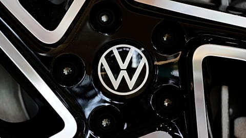 The logo of German car manufacturer Volkswagen is pictured at an ID.3 electric car at the transparent factory in Dresden, Germany, Wednesday, May 14, 2025. 