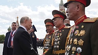 Russian President Vladimir Putin speaks with North Korean officers after the Victory Day military parade in Moscow, Russia, 9 May 2025.
