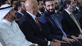 الرئيس السوري المؤقت أحمد الشرع ينظر إلى المبعوث الخاص إلى سوريا توم باراك أثناء حضو توقيع اتفاقية قطرية وتركية وأمريكية لتطوير مشروع للطاقة  29 مايو/أيار 2025
