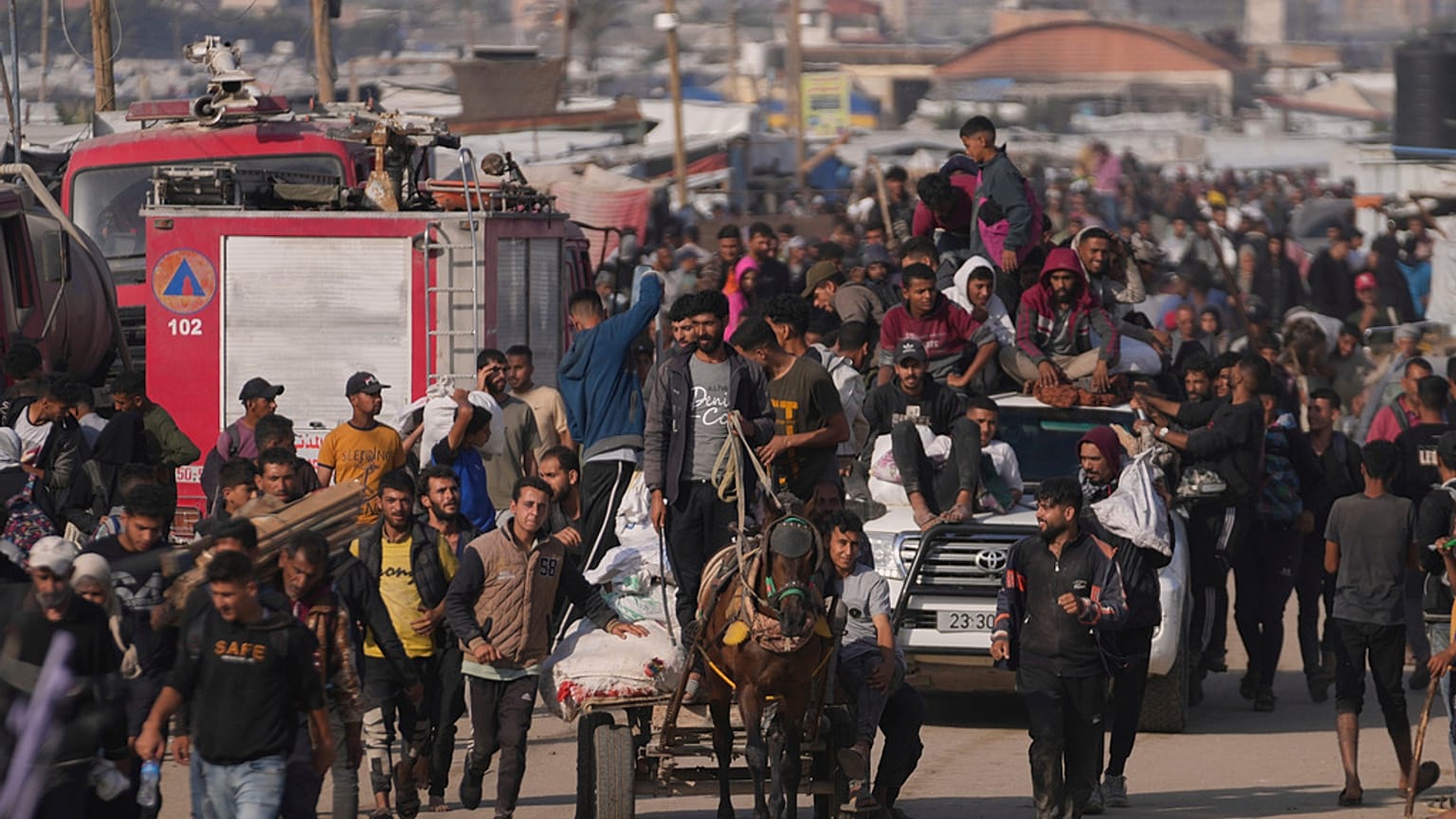 Palestinians carry boxes and bags containing food and humanitarian aid packages delivered by a U.S.-backed organization approved by Israel in the Gaza Strip, 1 June 2025