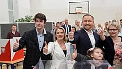 Presidential candidate Karol Nawrocki poses with family members after voting at a polling station during the presidential election runoff in Warsaw, 1 June 2025