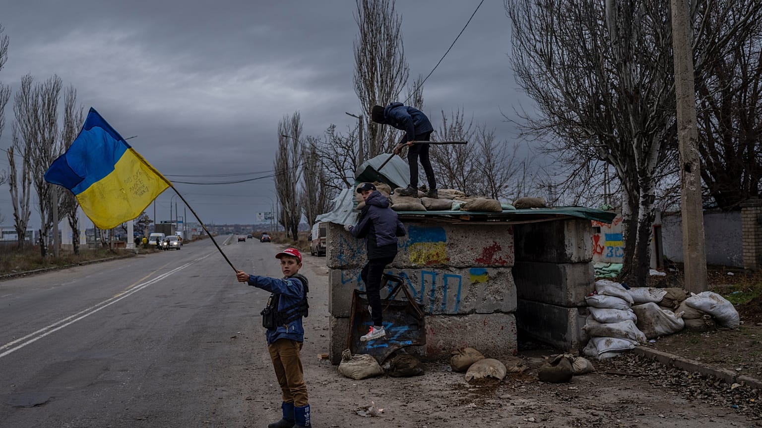 FILE - Ukrainian children play at an abandoned checkpoint in Kherson, southern Ukraine, Wednesday, Nov. 23, 2022. 