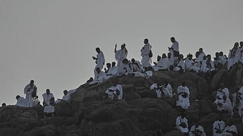 Muslim pilgrims pray atop rocky hill known as the Mountain of Mercy, on the Plain of Arafat, during the annual Hajj pilgrimage near Mecca, Saudi Arabia, June 5, 2025. 