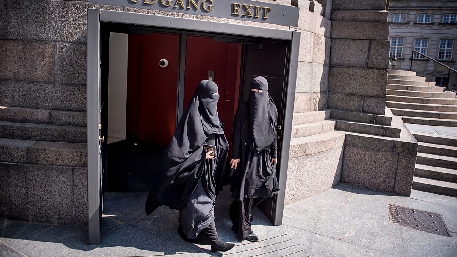FILE: Women wearing the niqab walk out of the exit doors of the Danish Parliament, at Christiansborg Castle, in Copenhagen, 31 May 2018