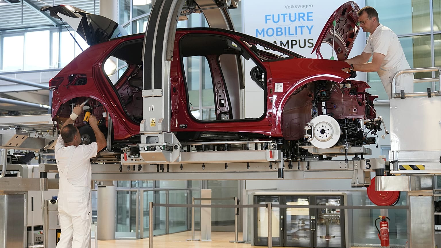 Employees of the German car manufacturer Volkswagen assemble an ID.3 electric car at the transparent factory in Dresden, Germany. 14 May 2025.