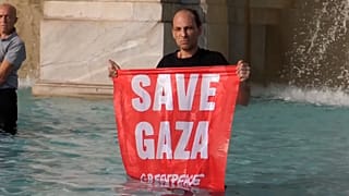 A man holds a banner that reads “Save Gaza” in Rome, Italy on June 6, 2025.