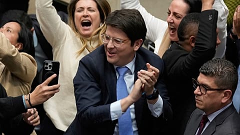 Turbay, presidential candidate for the right-wing Democratic Centre party, celebrates after voting against a labour reform referendum in Bogotá on 14 May.