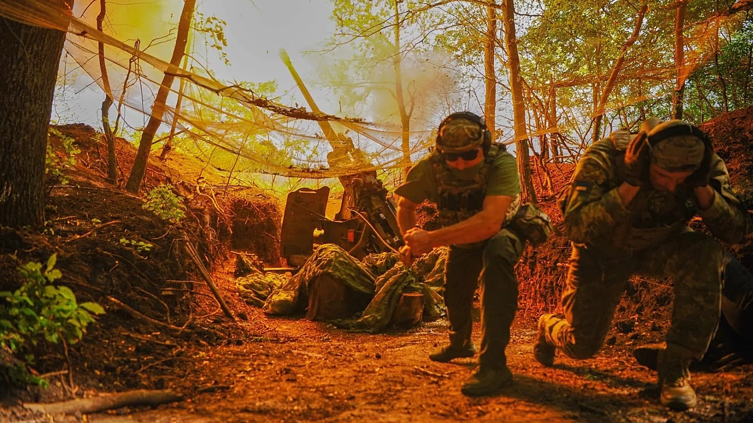 In this photo provided by Ukraine's 127th Separate Brigade of the Territorial Defense press service, soldiers fire toward Russian army positions near Kharkiv, Ukraine,