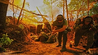 In this photo provided by Ukraine's 127th Separate Brigade of the Territorial Defense press service, soldiers fire toward Russian army positions near Kharkiv, Ukraine,