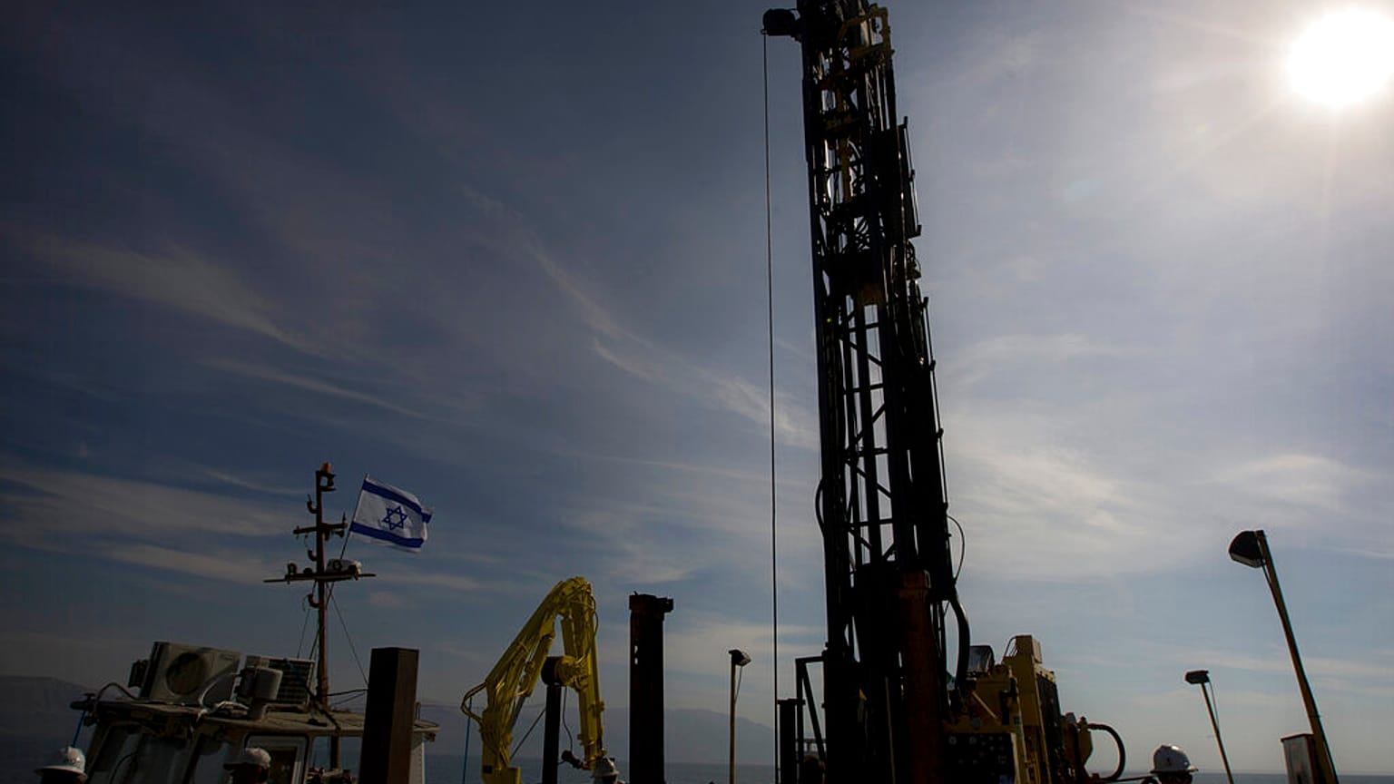 Workers dig for layers of sediment in the bottom of the Dead Sea on a drilling rig, Tuesday, Nov. 23, 2010. 