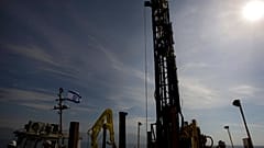 Workers dig for layers of sediment in the bottom of the Dead Sea on a drilling rig, Tuesday, Nov. 23, 2010. 