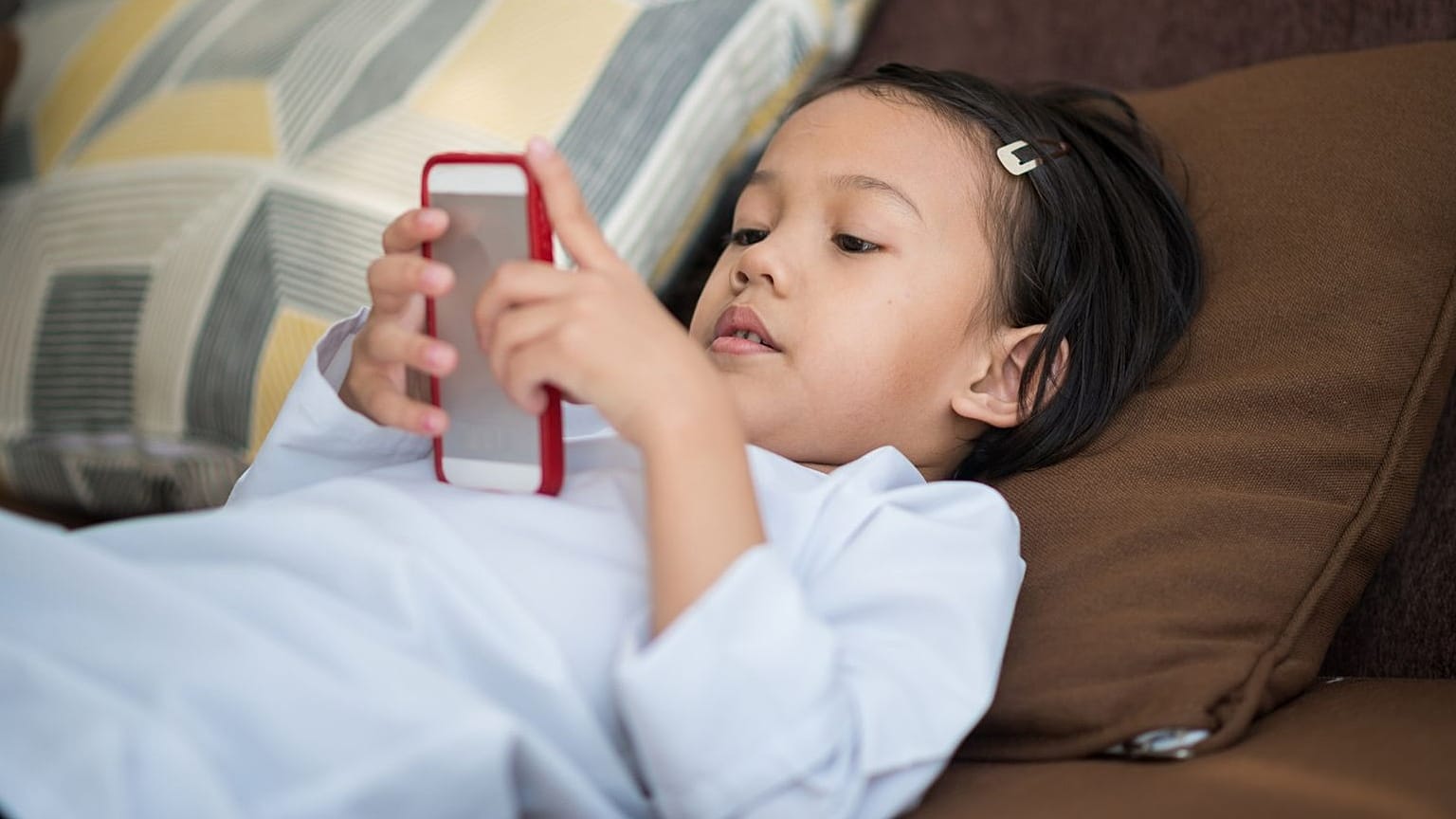 A child watches content on a mobile device.