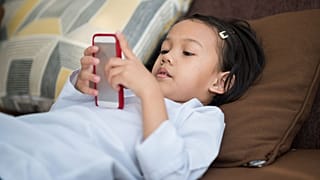 A child watches content on a mobile device.