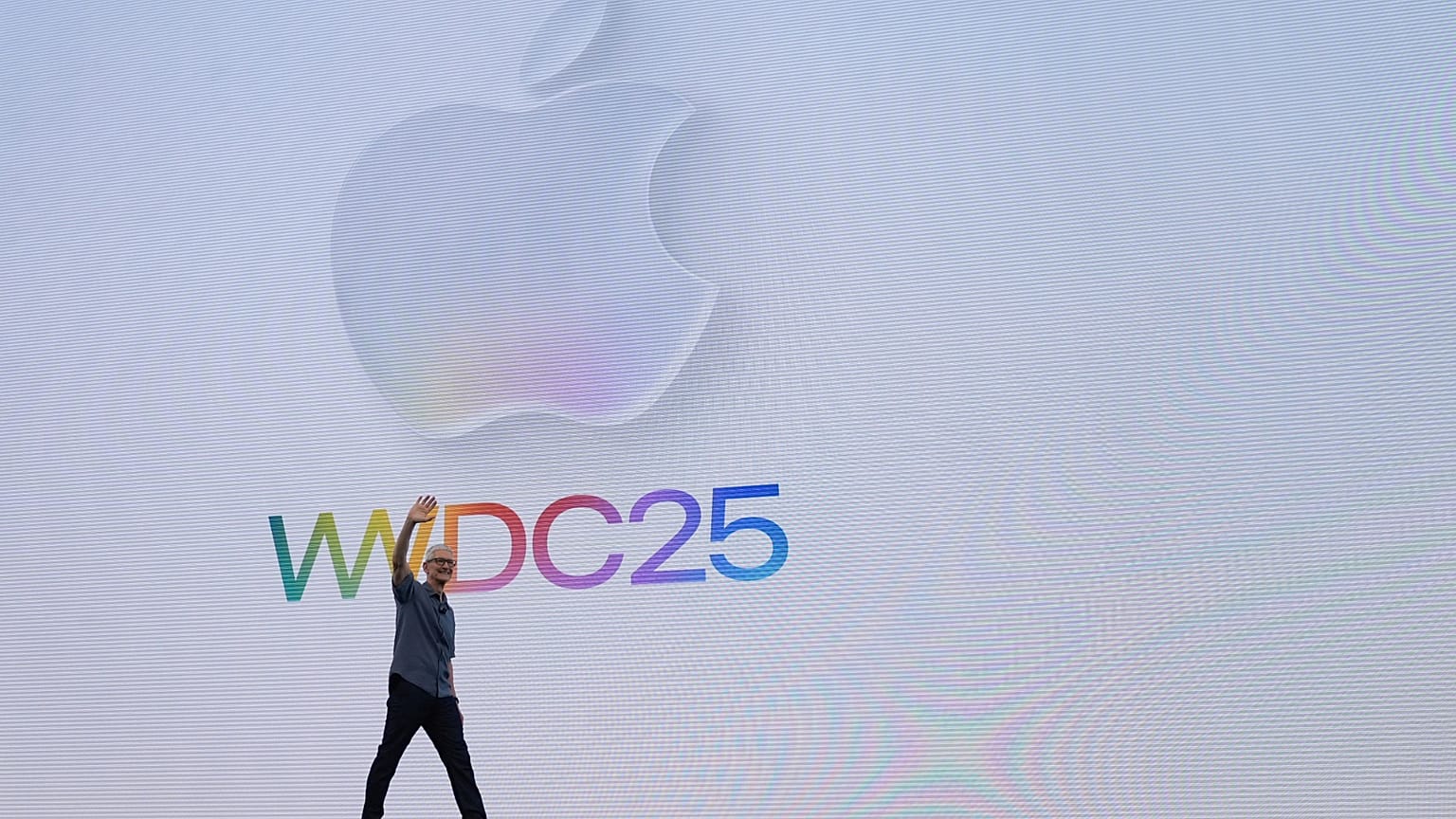 Apple CEO Tim Cook waves to attendees during an event on the Apple campus in Cupertino, Calif., Monday, June 9, 2025.