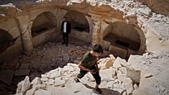 A boy emerges from a pit after exploring 1,500-year-old Byzantine tombs uncovered during reconstruction in war-damaged Maarat al-Numan, Idlib, Syria, on 30 May 2025.