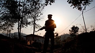 A rebel fighter stands at a frontline outpost facing no man's land in Lawa Yang in northern Kachin state, 20 March, 2018