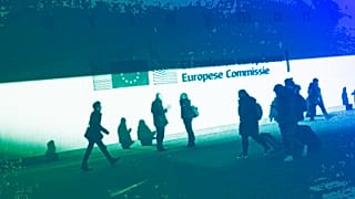People walk past the European Commission headquarters in Brussels, February 2020