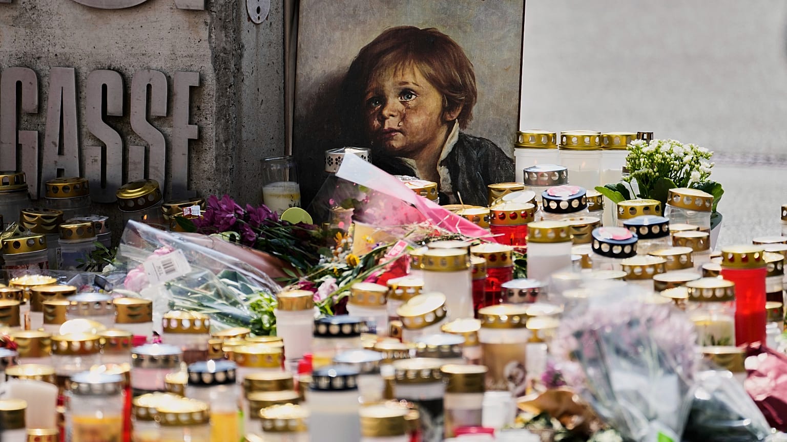 Candles, flowers and a picture placed at the entrance of at a school where a former student opened fire in Graz, 12 June, 2025