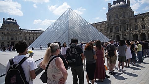 Lines stretch outside the Louvre in Paris as opening delayed for undisclosed emergency meeting