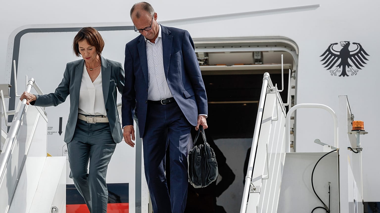 German Chancellor Friedrich Merz, right, and his wife Charlotte Merz arrive in Calgary, Alberta, Sunday, June 15, 2025, to attend the G7 Leaders