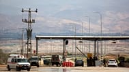 An Israeli soldier stands at the entrance to the Allenby border crossing, the main border crossing for Palestinians from the West Bank traveling to Jordan, 10 March, 2014