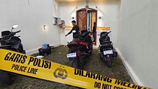 Plain-clothed police officers are seen at a villa in Badung on the resort island of Bali, Indonesia, Saturday, June 14, 2025
