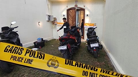 Plain-clothed police officers are seen at a villa in Badung on the resort island of Bali, Indonesia, Saturday, June 14, 2025
