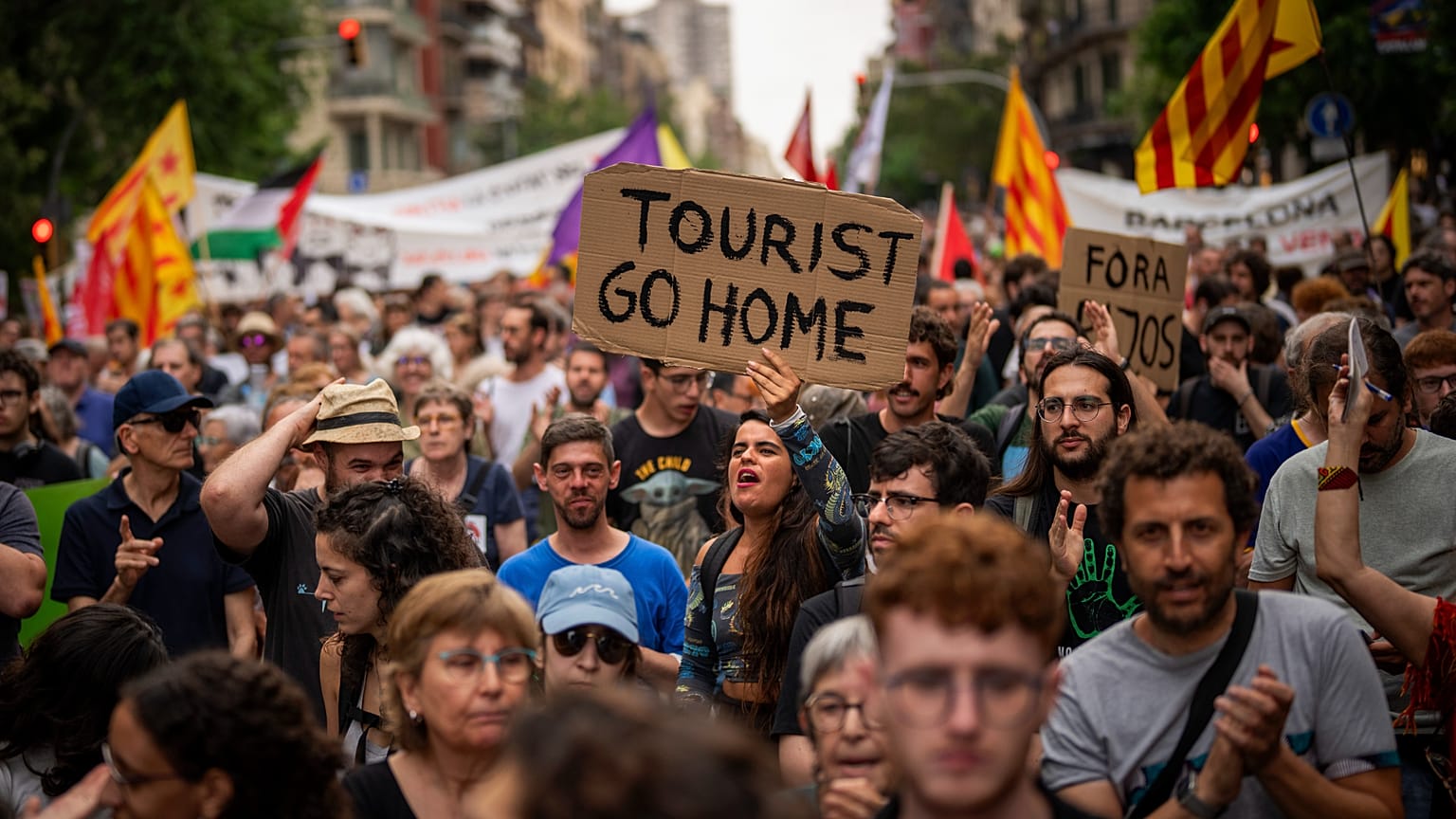 Demonstrators march shouting slogans against the Formula 1 Barcelona Fan Festival in downtown Barcelona, 19 June, 2024