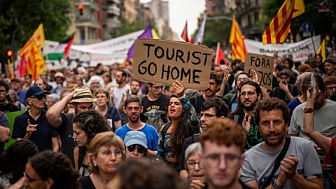 Demonstrators march shouting slogans against the Formula 1 Barcelona Fan Festival in downtown Barcelona, 19 June, 2024