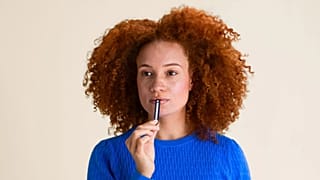 A woman uses Inne's progesterone-testing strip.