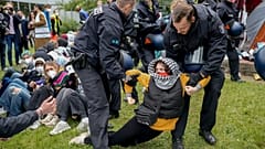 Während einer pro-palästinensischen Demonstration der Gruppe "Student Coalition Berlin" wird eine Frau von Polizeibeamten weggetragen. 