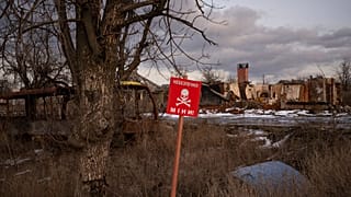 FILE: A sign that reads "Mines" is seen in the village of Kamyanka, on the outskirts of Izium, Ukraine, Feb. 19, 2023