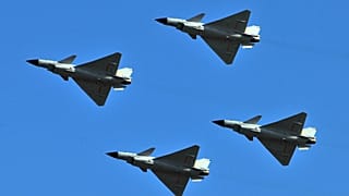 J-10 jet fighters perform in formation to celebrate the 60th anniversary of the People's Liberation Army Air Force in Beijing, China, 15 November 2009.